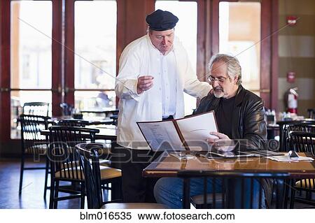 Caucasian man talking to chef in restaurant View Large Photo Image Stock Photography - Caucasian man talking to chef in restaurant. Fotosearch
