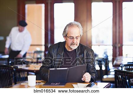 Picture - Caucasian man using tablet computer. Fotosearch