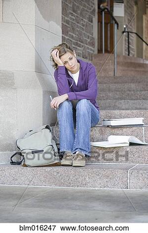 Stock Photo - Caucasian student sitting on campus. Fotosearch