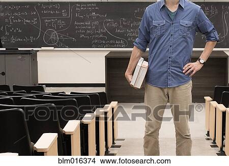 Picture - Caucasian student standing in classroom. Fotosearch