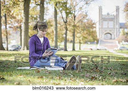 Stock Image - Caucasian student studying on campus. Fotosearch