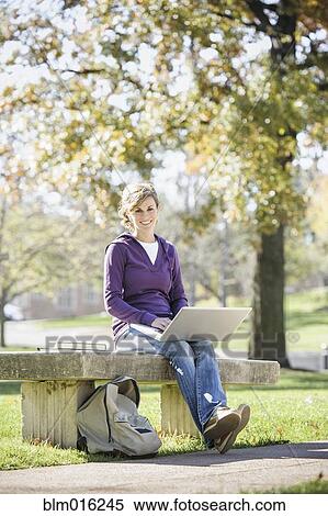 Caucasian student using laptop on campus View Large Photo Image Stock Photography - Caucasian student using laptop on campus. Fotosearch