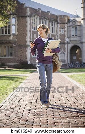 Caucasian student walking on campus View Large Photo Image Stock Photo - Caucasian student walking on campus. Fotosearch