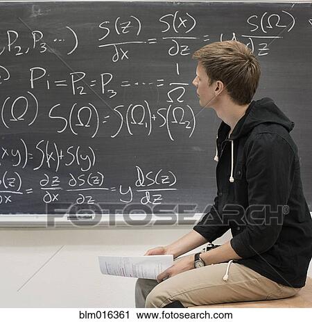 Caucasian student working from blackboard View Large Photo Image Stock Image - Caucasian student working from blackboard. Fotosearch