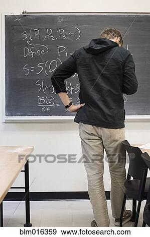 Caucasian student working from blackboard View Large Photo Image Stock Photo - Caucasian student working from blackboard. Fotosearch
