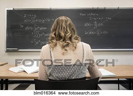 Picture - Caucasian student working in classroom. Fotosearch