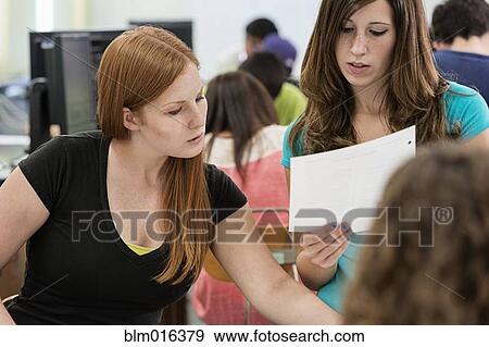 Stock Photo - Caucasian students working together in classroom. Fotosearch