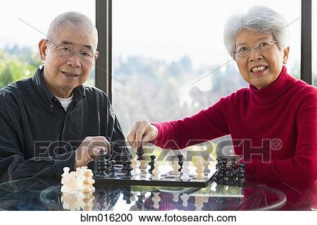 Chinese couple playing chess View Large Photo Image Stock Image - Chinese couple playing chess. Fotosearch