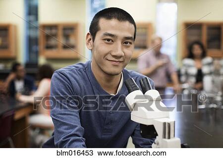 Chinese student at microscope in lab classroom View Large Photo Image Stock Image - Chinese student at microscope in lab classroom. Fotosearch