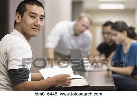 Chinese student reading book at desk View Large Photo Image Stock Photography - Chinese student reading book at desk. Fotosearch