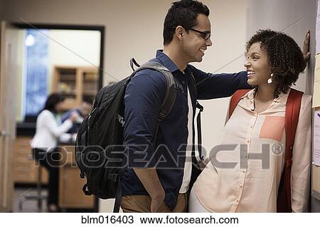 Stock Image - Couple talking in hallway. Fotosearch