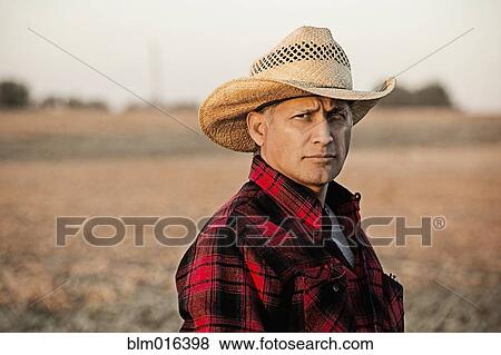 Hispanic farmer standing in crop field View Large Photo Image Stock Photo - Hispanic farmer standing in crop field. Fotosearch