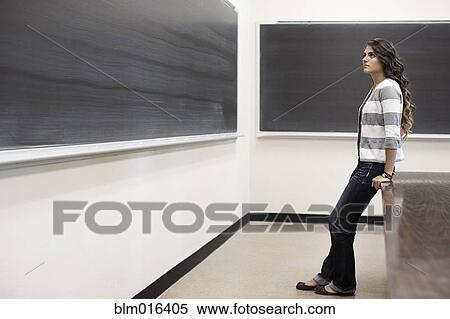 Stock Photography - Hispanic student standing in classroom. Fotosearch