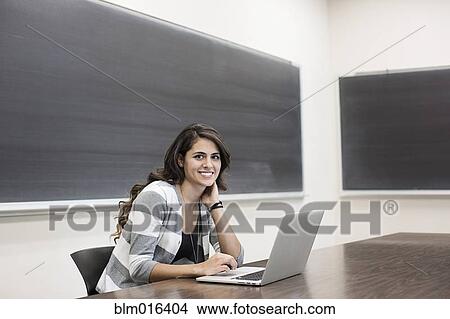 Hispanic student using laptop in classroom View Large Photo Image Picture - Hispanic student using laptop in classroom. Fotosearch