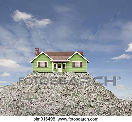 Stock Photo - House sitting on pile of dollar bills. Fotosearch