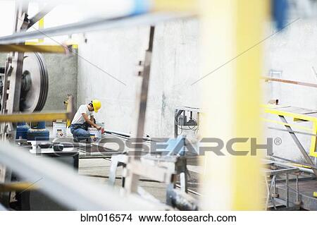 Picture - Man working in manufacturing plant. Fotosearch