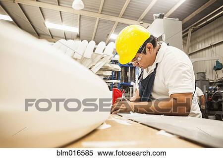 Man working in manufacturing plant View Large Photo Image Stock Photography - Man working in manufacturing plant. Fotosearch
