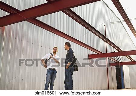 Men talking outside manufacturing plant View Large Photo Image Stock Image - Men talking outside manufacturing plant. Fotosearch