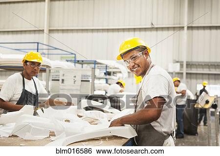 Stock Photograph - Men working in manufacturing plant. Fotosearch