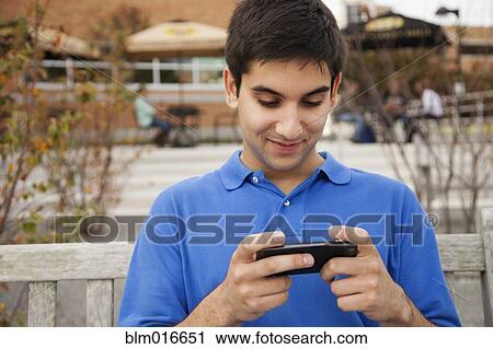 Middle Eastern student using cell phone View Large Photo Image Stock Image - Middle Eastern student using cell phone. Fotosearch