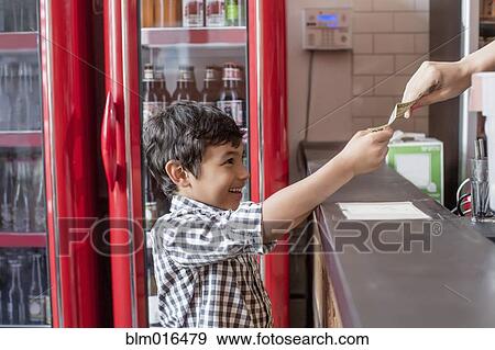 Stock Photo - Mixed race boy buying food in restaurant. Fotosearch