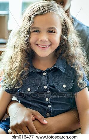 Mixed race girl sitting in lap View Large Photo Image Stock Photo - Mixed race girl sitting in lap. Fotosearch