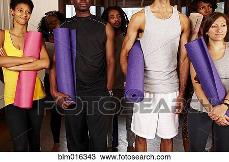 Stock Image - People holding yoga mats. Fotosearch