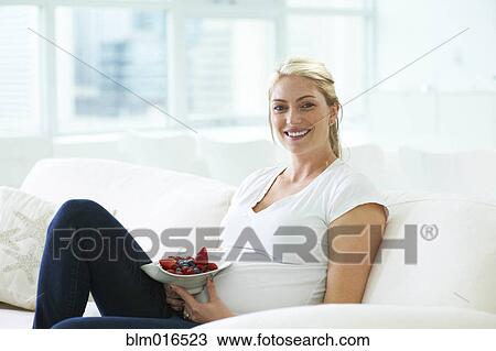 Pregnant Caucasian woman eating strawberries View Large Photo Image Stock Image - Pregnant Caucasian woman eating strawberries. Fotosearch