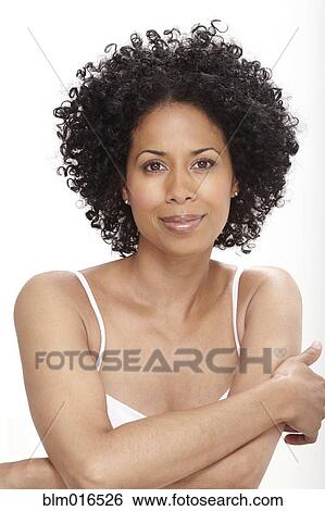 Stock Photograph - Smiling Black woman with arms crossed. Fotosearch
