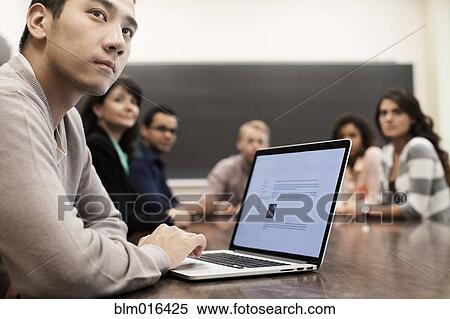Student using laptop in classroom View Large Photo Image Stock Photography - Student using laptop in classroom. Fotosearch