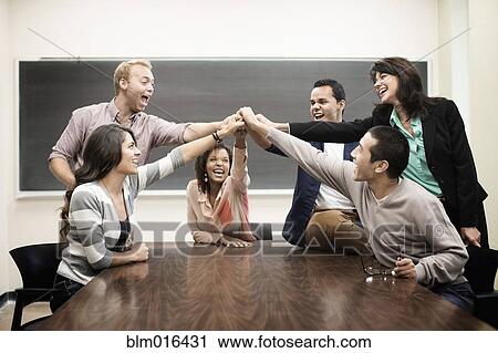 Stock Image - Students cheering in classroom. Fotosearch