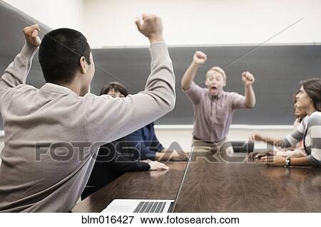 Stock Photo - Students cheering in classroom. Fotosearch