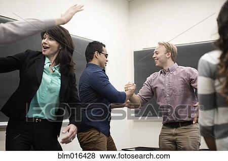 Stock Photo - Students cheering in classroom. Fotosearch