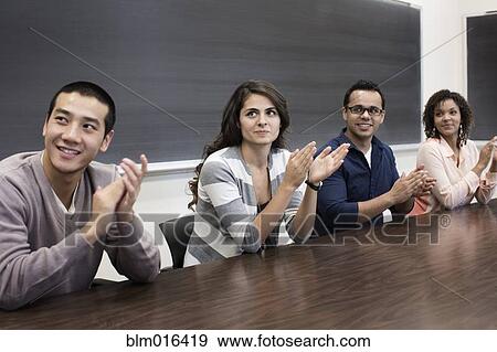 Stock Photo - Students clapping in classroom. Fotosearch