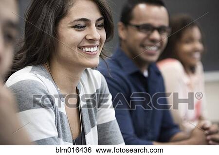 Stock Photograph - Students laughing in classroom. Fotosearch