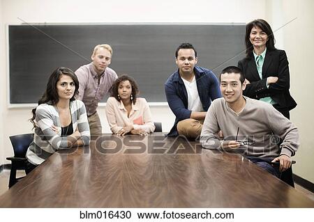 Stock Image - Students smiling in classroom. Fotosearch