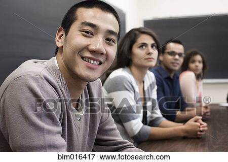 Stock Photo - Students smiling in classroom. Fotosearch