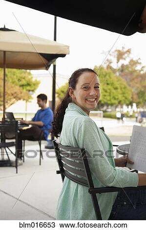 Students studying at tables on campus View Large Photo Image Stock Image - Students studying at tables on campus. Fotosearch
