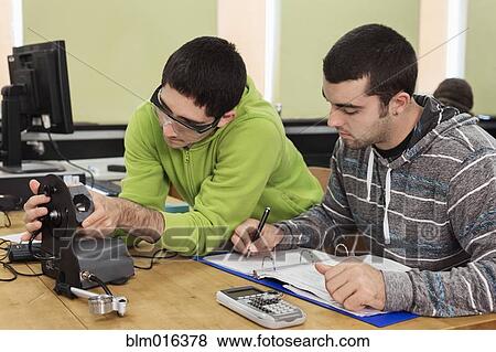 Stock Photo - Students working together in classroom. Fotosearch