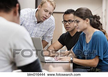 Students working together on laptop View Large Photo Image Picture - Students working together on laptop. Fotosearch