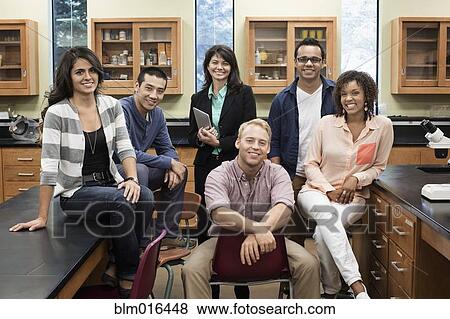 Teacher and students smiling in lab classroom View Large Photo Image Stock Photo - Teacher and students smiling in lab classroom. Fotosearch
