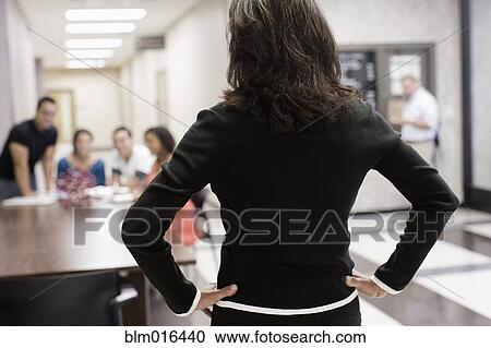 Teacher watching students in hallway View Large Photo Image Stock Image - Teacher watching students in hallway. Fotosearch