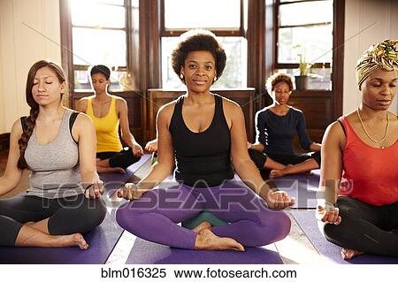 Women meditating in yoga class View Large Photo Image Stock Photography - Women meditating in yoga class. Fotosearch