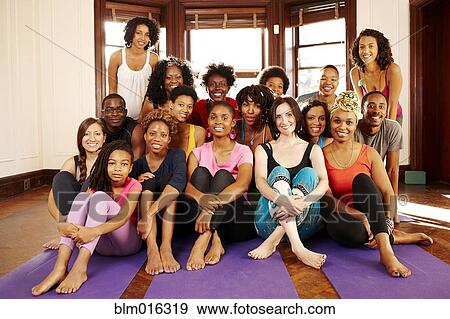 Stock Photo - Women smiling in yoga class. Fotosearch