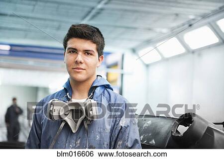 Stock Photograph - Worker smiling in manufacturing plant. Fotosearch