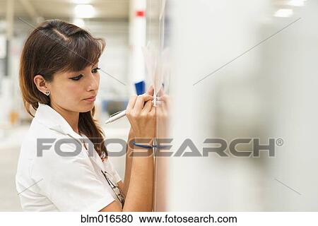 Worker writing on whiteboard View Large Photo Image Stock Image - Worker writing on whiteboard. Fotosearch