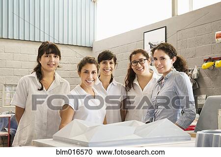 Workers smiling in manufacturing plant View Large Photo Image Stock Image - Workers smiling in manufacturing plant. Fotosearch