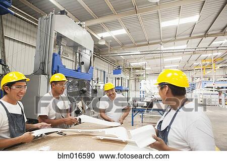 Workers talking in manufacturing plant View Large Photo Image Stock Image - Workers talking in manufacturing plant. Fotosearch