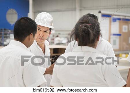 Workers talking in manufacturing plant View Large Photo Image Stock Image - Workers talking in manufacturing plant. Fotosearch