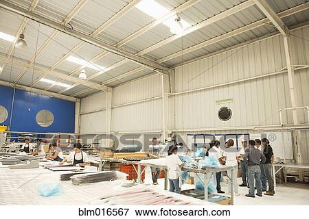 Workers talking in manufacturing plant View Large Photo Image Stock Photo - Workers talking in manufacturing plant. Fotosearch